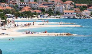 a group of people on a beach in the water at apartmenttwelve in Trogir