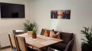 a dining room with a table and chairs and a tv at Apart Ritzl in Fügen