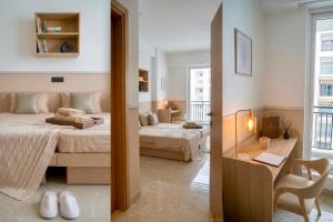 a bedroom with two beds and a table and a mirror at AS Living Guest House - A boutique stay near Apollo Hospital, City Center Mall, PhysicsWallah, Allen, SPM in Guwahati