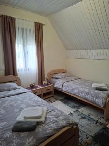 a room with two beds and a window at Sunrise in Žabljak