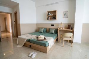 a bedroom with a bed with a chair and a desk at AS Living Guest House - A boutique stay near Apollo Hospital, City Center Mall, PhysicsWallah, Allen, SPM in Guwahati +24 photos