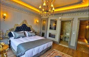 a bedroom with a king sized bed and a chandelier at REAL KiNG SUiTE in Trabzon