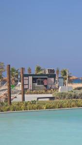 a bus parked next to a beach with palm trees at D-bay north coast 4 bed rooms villa minimum stay 3 nights in Zāwiyat ‘Abd al Mun‘im