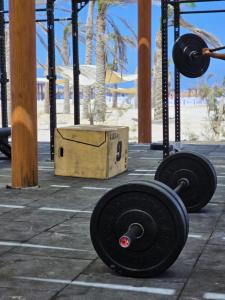 a gym with two dumbbells and a box at D-bay north coast 4 bed rooms villa minimum stay 3 nights in Zāwiyat ‘Abd al Mun‘im