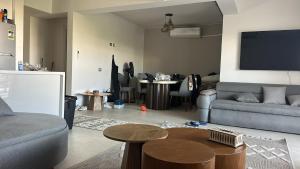 a living room with a couch and a table at D-bay north coast 4 bed rooms villa minimum stay 3 nights in Zāwiyat ‘Abd al Mun‘im