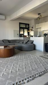a living room with a couch and a table at D-bay north coast 4 bed rooms villa minimum stay 3 nights in Zāwiyat ‘Abd al Mun‘im