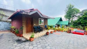 a small house with plants in front of it at Coorg Annu Stay in Madikeri