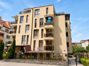 a tall building with windows and balconies on it at AM Sea Studios in Ravda