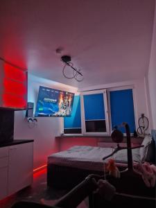 a bedroom with a bed and a flat screen tv at Moon Love in Pakopi