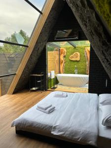 a bedroom with a large bathroom with a bath tub at Dilijan House in Dilijan