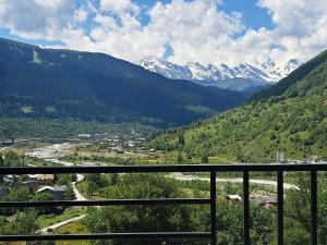 a view of a valley with snow capped mountains at Guesthouse Laurbili in Mestia
