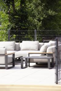 a group of couches and a coffee table on a patio at MALIA - Alpine Hideaway in Pertisau