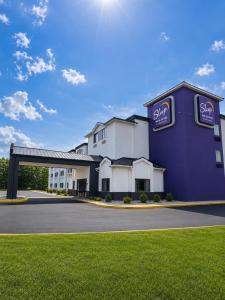 a large purple building with a sign on it at Sleep Inn & Suites Peoria North in Peoria