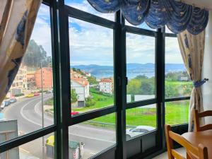 a window with a view of a street at Gran Paraíso Raxo in Raxó