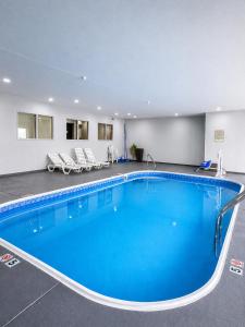 a large pool in a hotel room with blue water at Sleep Inn & Suites Peoria North in Peoria