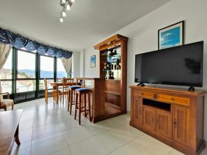 a living room with a large flat screen tv at Gran Paraíso Raxo in Raxó