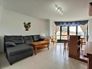 a living room with a couch and a table at Gran Paraíso Raxo in Raxó