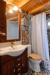 a bathroom with a sink and a toilet at Mareliva Retreat in Trinísia +44 photos