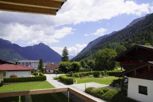a view from the balcony of a resort with mountains at MALIA - Alpine Hideaway in Pertisau