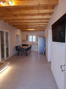 a large living room with a table and chairs at Sun & Stones Suite in Agrari