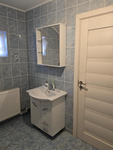 a bathroom with a sink and a mirror at Vila Pângărați in Pangarati +23 photos