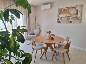 a dining room with a table and chairs and a plant at 4 stars - apartments Senj in Senj