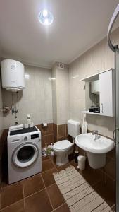 a bathroom with a washing machine and a toilet at Valverde Apartment Vlašić in Šišava +11 photos