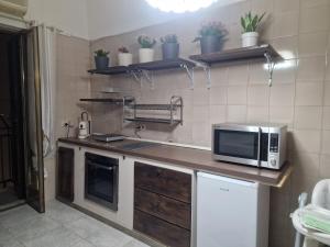 a kitchen with a microwave sitting on a counter at Frangio' in Noci +8 photos