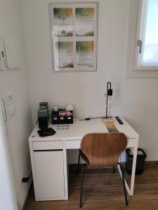a white desk with a chair in a room at PiaveHome in San Donà di Piave
