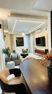 a living room with a couch and a table at Mandys Guest House in Yaoundé +5 photos