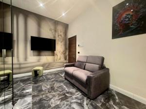 a living room with a couch and a flat screen tv at Mirarti Boutique Hotel - Witamy in Rapallo