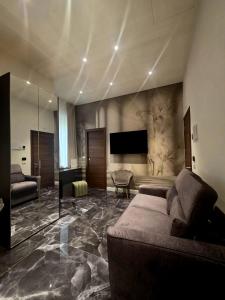 a large living room with a couch and a television at Mirarti Boutique Hotel - Witamy in Rapallo