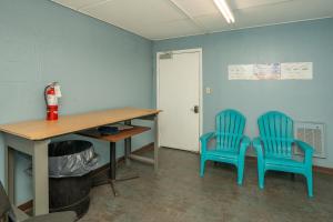 two blue chairs sitting next to a desk and a table at Olde Gatlinburg Rentals in Gatlinburg