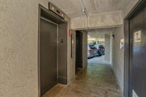 a hallway with a door in a building with parked cars at Olde Gatlinburg Rentals in Gatlinburg