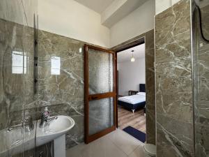 a bathroom with a sink and a shower and a toilet at ARBI GUEST House in Kukës