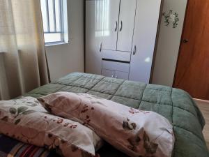 a bedroom with a bed with two pillows on it at Casa hogareña Pequeña in Ica