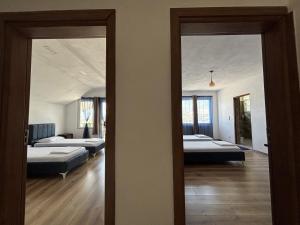 a room with two beds and two mirrors at ARBI GUEST House in Kukës