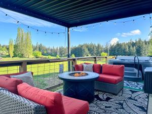 a patio with two couches and a table on a deck at The Cottage on the Farm in Ladysmith