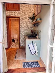 a bathroom with a sink and a toilet in a room at The Willow Nest in Hambleden +9 photos