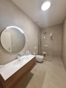 a bathroom with a sink and a toilet and a mirror at 4 stars - apartments Senj in Senj