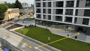 an aerial view of a building with a green lawn in front of it at LaRa Apartament in Timişoara