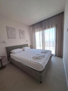 a bedroom with a large bed and a large window at 4 stars - apartments Senj in Senj