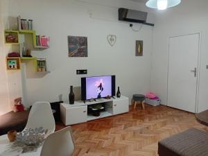 a living room with a flat screen tv on a white cabinet at Katata Apartment One -Bedrom in Podgorica