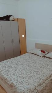 a bedroom with a bed and a dresser and a bed sidx sidx at Katata Apartment One -Bedrom in Podgorica