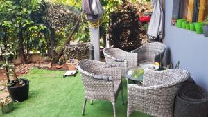 a group of chairs and a table on a lawn at Katata Apartment One -Bedrom in Podgorica