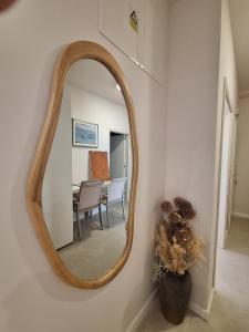 a mirror on a wall with a dining room at 4 stars - apartments Senj in Senj