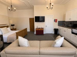 a living room with a couch and a bed at 55 Studio 1 Uplands in Swansea