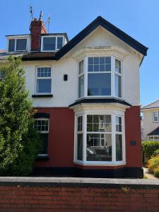 a red and white house with a large window at 55 Studio 1 Uplands in Swansea