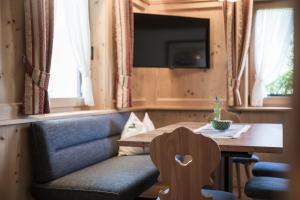 a living room with a couch and a wooden table at Chalet Aldian Dolomites in Selva di Val Gardena +47 photos