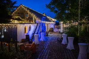 a courtyard with white chairs and christmas lights at Hostinec U Rypáka in Vrátkov